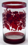 Glass with ruby stainning and grape leaves with grapes